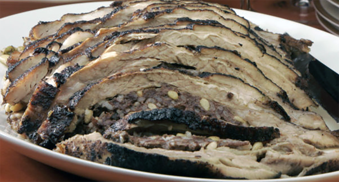 sliced stuffed roast breast of veal on a plate