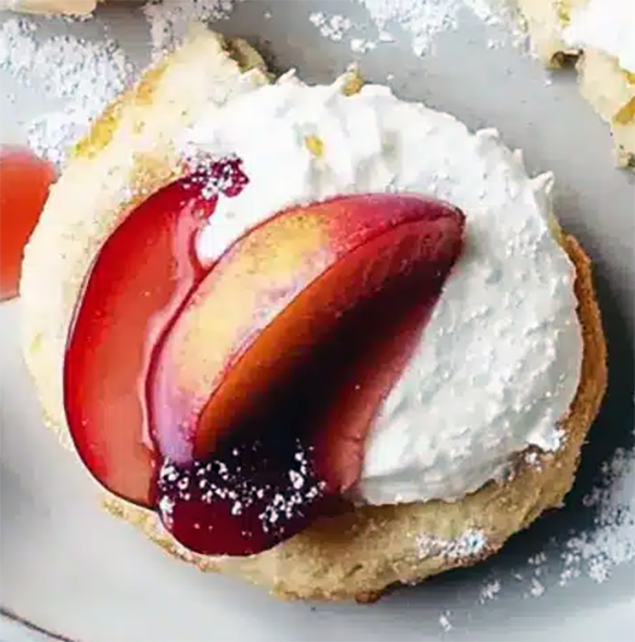 shortcake-style cake topped with mascarpone cheese and lightly-stewed plum slices
