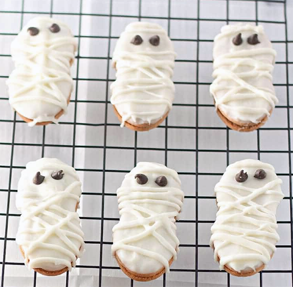 nut butter ghost cookies on a wire rack