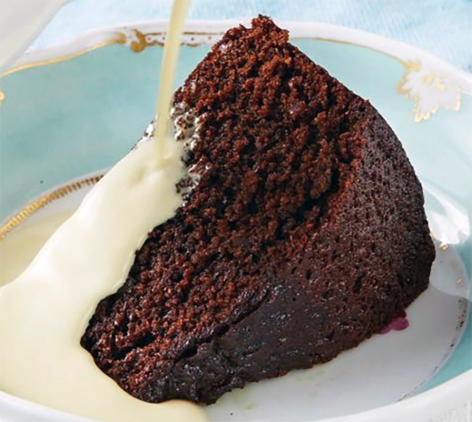 wedge of treacle ginger cake served with cream