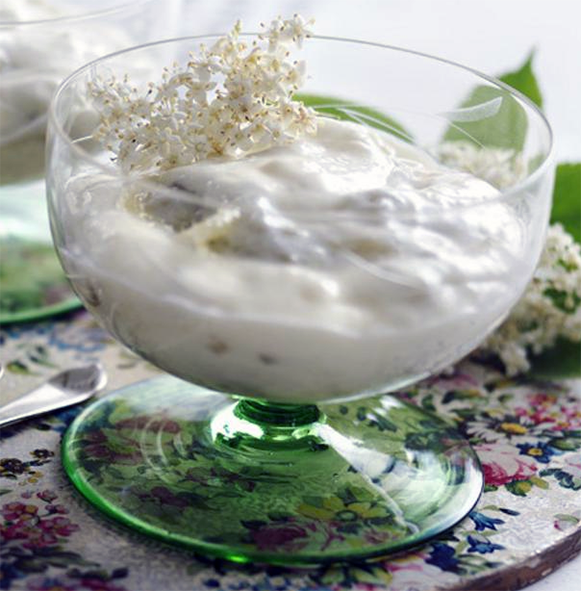 gooseberry and elderflower fool served in a glass and garnished with a sprig of elderflower