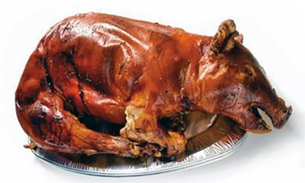 whole roast suckling pig on a foil plate
