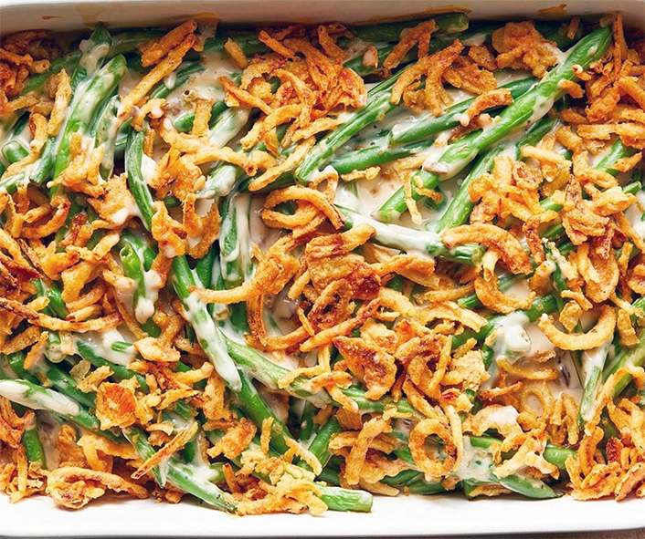 green bean and crisp onion casserole with cream of mushroom soup in a casserole dish