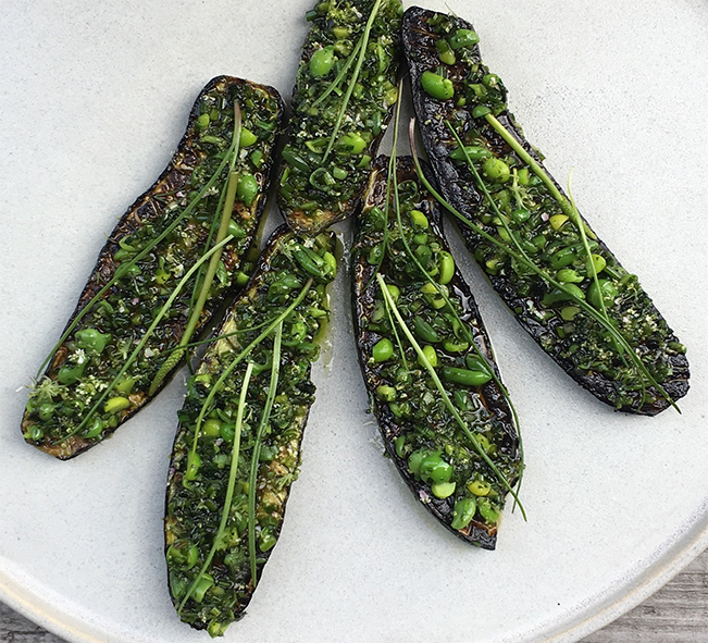 grilled courgette strips topped with sea arrowgrass and peas