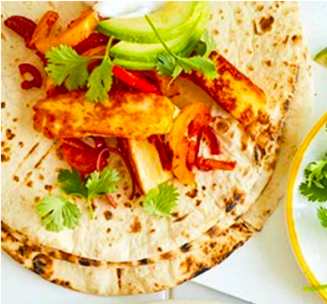 fried, spiced halloumi and avocado slices on a flour tortilla