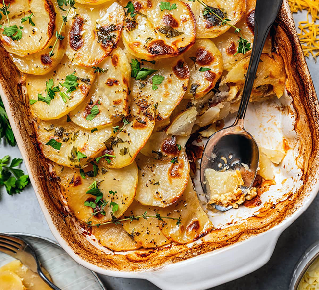 layered autumnal hotpot of lamb, potatoes, pumpkin and vegetables cooked in a baking dish