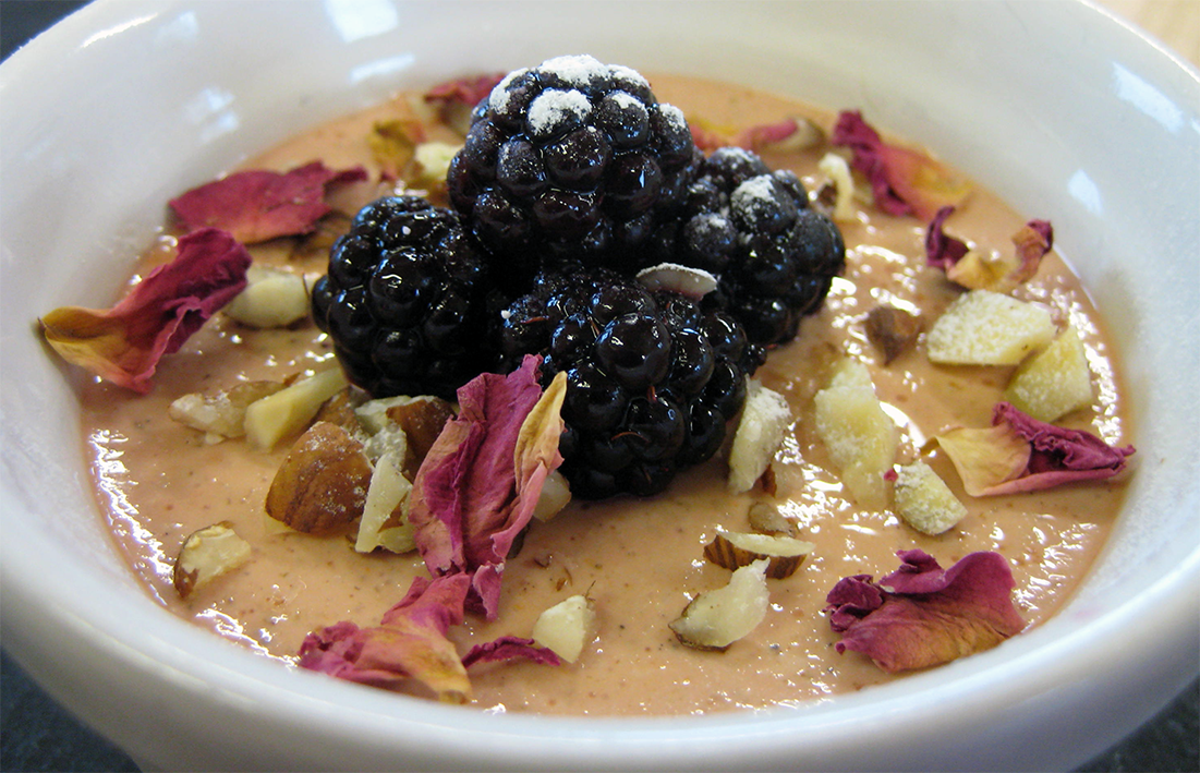 carrageen pudding set in a bowl and served topped with nuts, rose petals and blackberries</a>