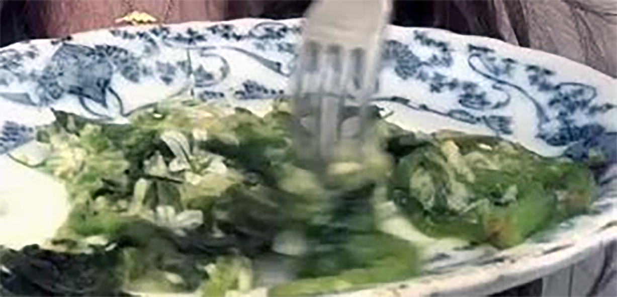 common hogweed shoots on a plate with chilli-cheese sauce