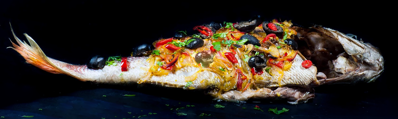 baked red snapper topped with coriander leaves, black olives bell peppers