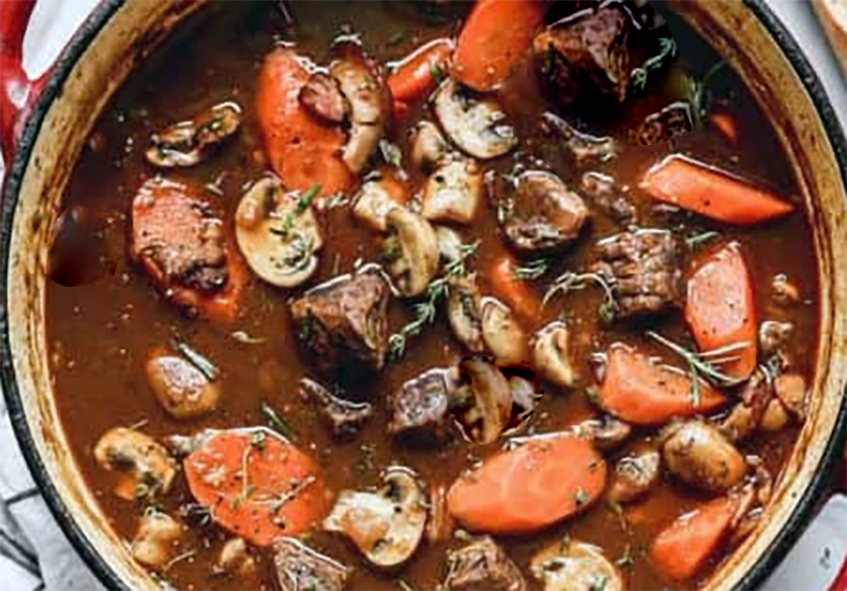 Northern Irish beef stew of beef, bacon, onions, mushrooms and carrots in a casserole dish