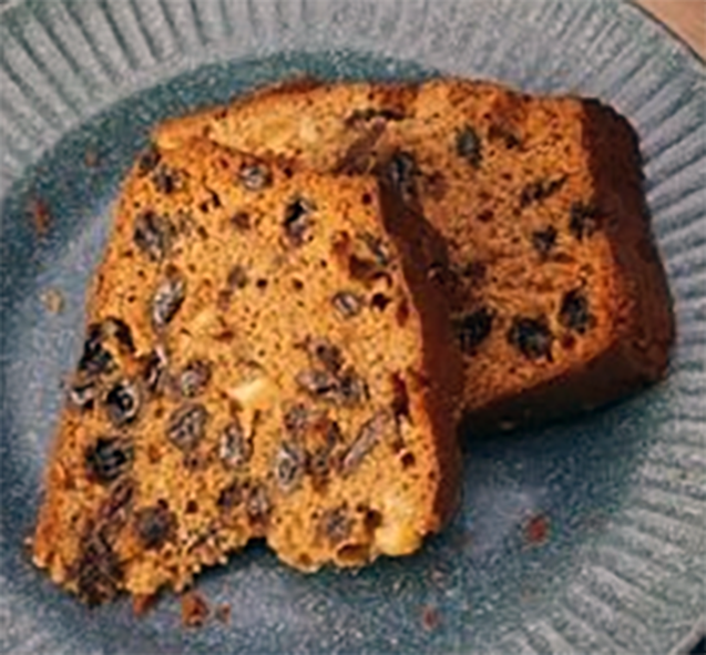 two slices of Irish plum cake, spiced and fruited tea cake served on a plate
