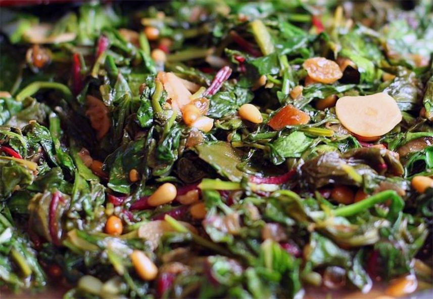 Dandelion leaves wilted with oil, garlic, anchovy paste, pine nuts and capers