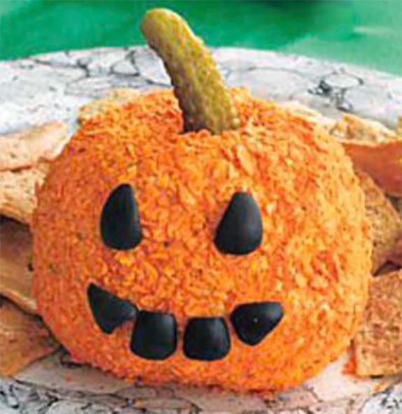 cheese ball decorated as a jack o'lantern served with crackers on a plate