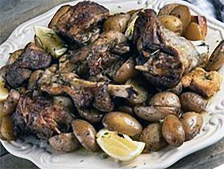 roast leg of lamb served on a bed of new potatoes