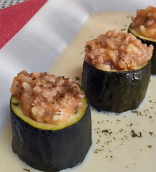 courgette rounds stuffed with arranged upright on a rectangular plate
