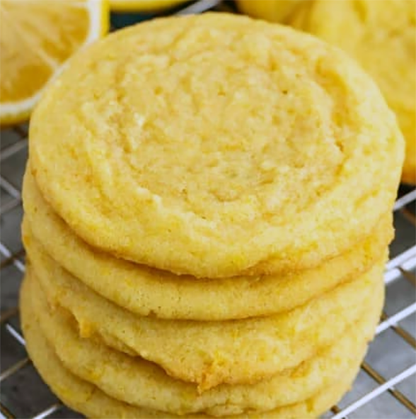 lemon pudding cookies piled on a wire rack