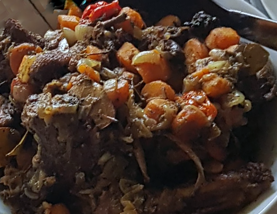 Libate, DR Congo duck with carrots, onions and tomatoes served in a bowl topped with hot chillies