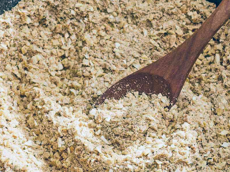 dried onion soup powder in a bowl with a wooden spoon