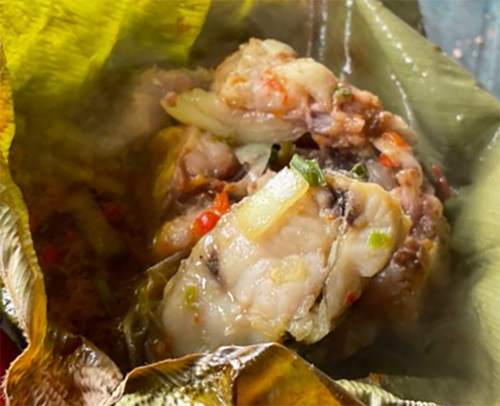fish steak steamed in banana leaf served in the banana leaf