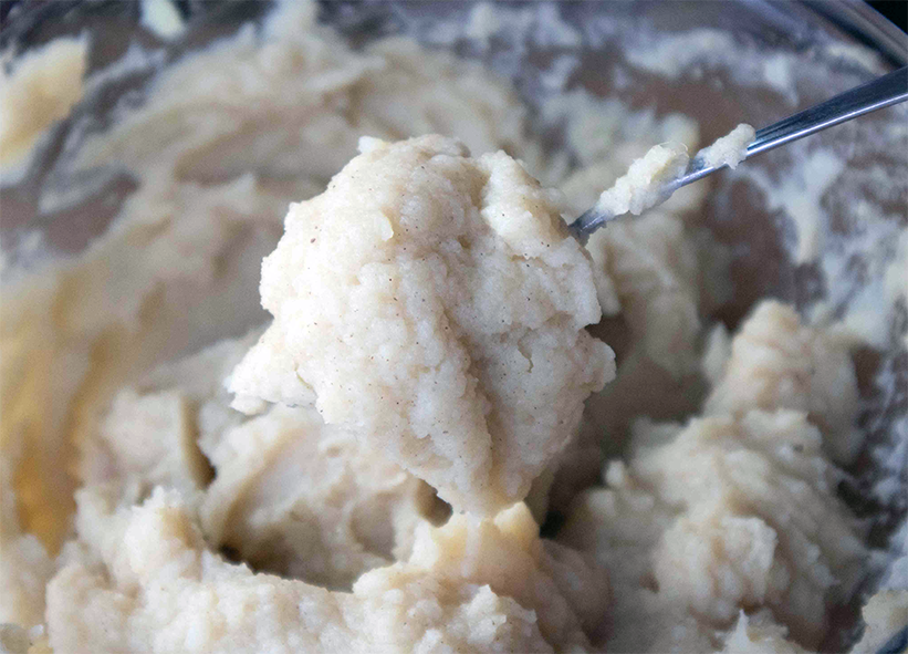sweetened and mashed white sweet potatoes blended with mafura oil in a bowl