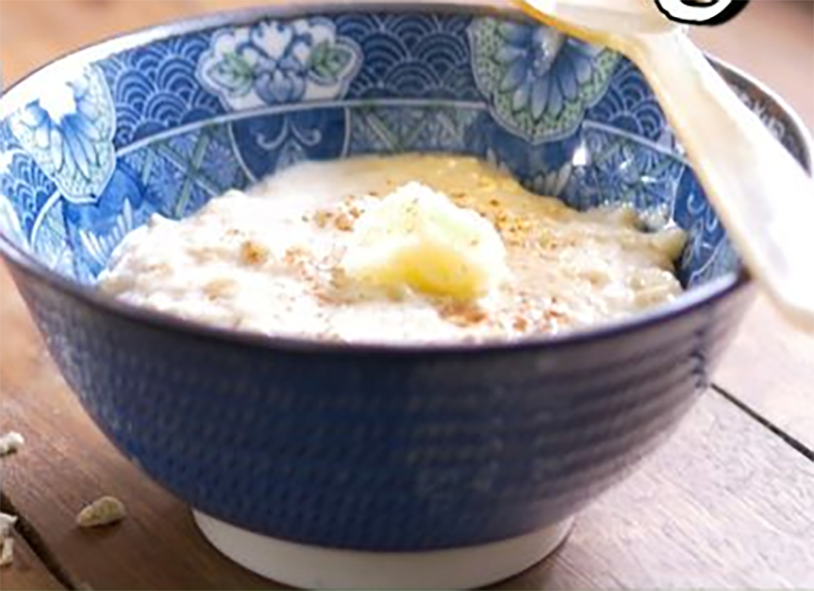 hasty pudding topped with a pat of butter in a bowl