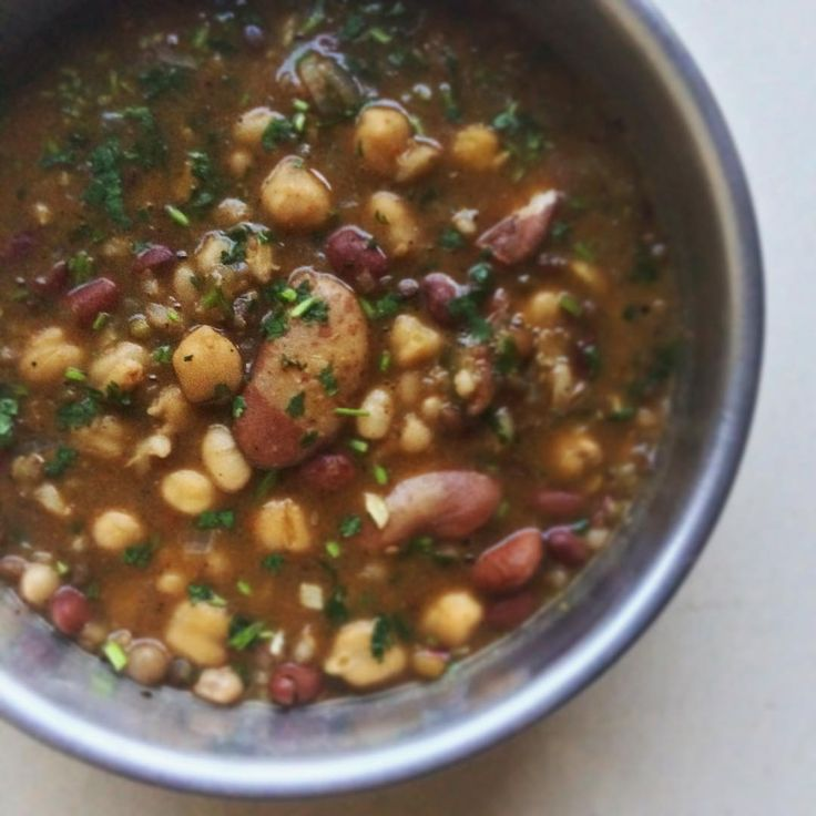 Makhlouta, Lebanese mixed bean soup in a serving bowl garnished with flat-leaf parsley