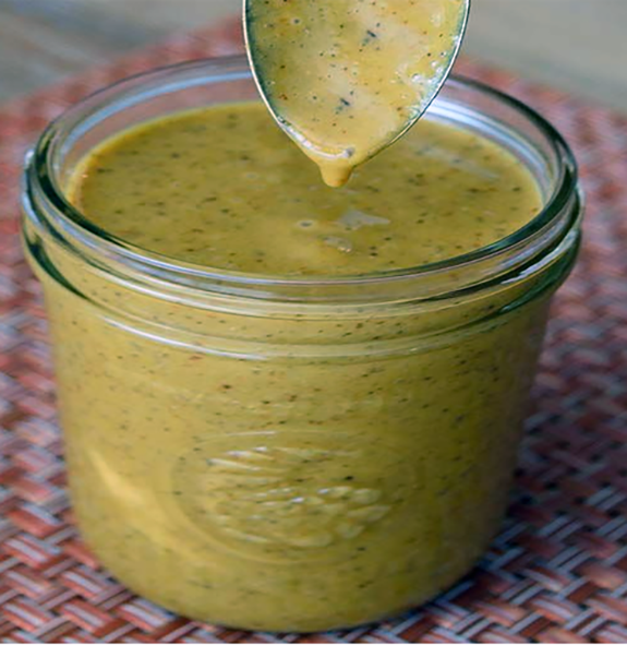 home-made mustard in a glass jar with a spoon