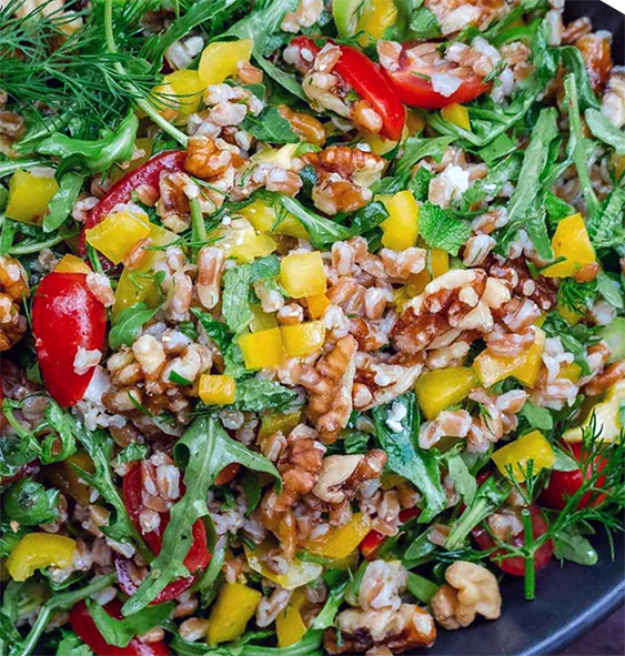 Mediterranean-style farro salad with rocket and walnuts served on a plate