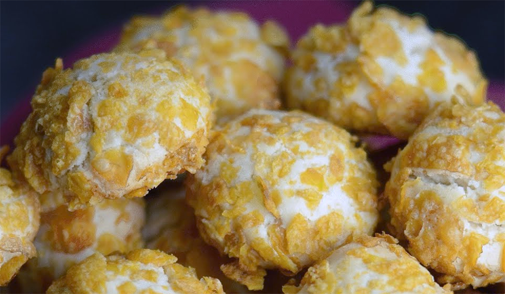 pile of crushed cornflake coated melting moment biscuits