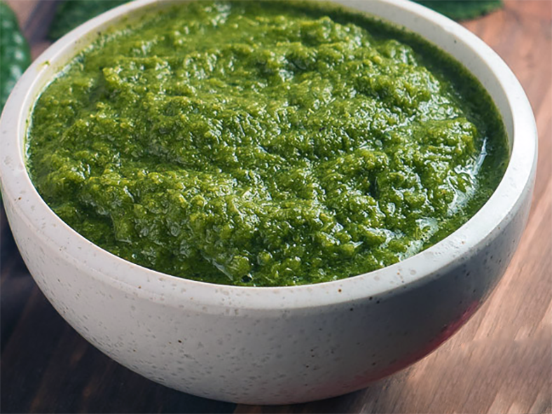mint chutney with chillies and coriander leaves served in a bowl