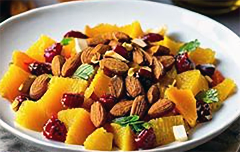 orange salad with dates and almonds in a shallow bowl