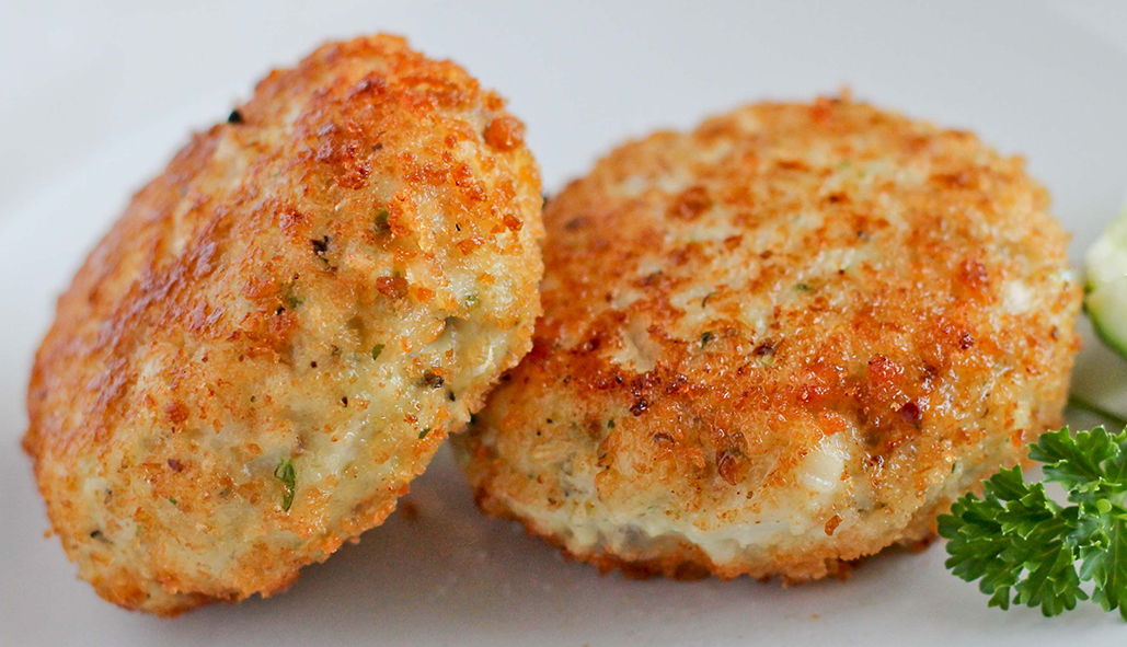 two breaded fish cakes on a plate