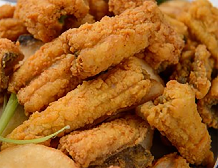 breaded and fried eel pieces piled on a plate