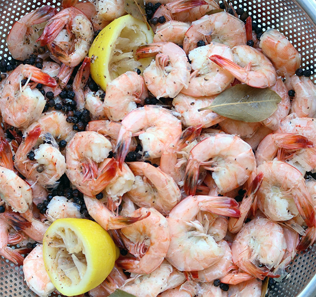 boiled and partly peeled prawns in a sieve