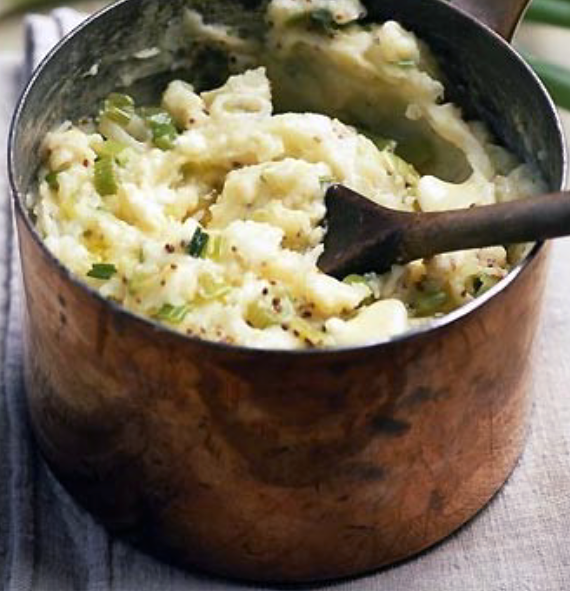 mustard champ mashed in a saucepan with a wooden spoon