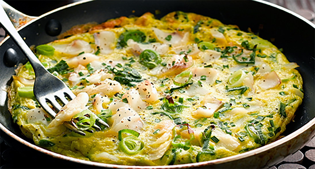 Open Smoked Haddock and Leek Omelette in a frying pan