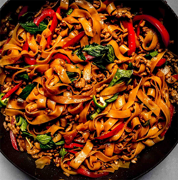 pad kee mao noodles in a wok