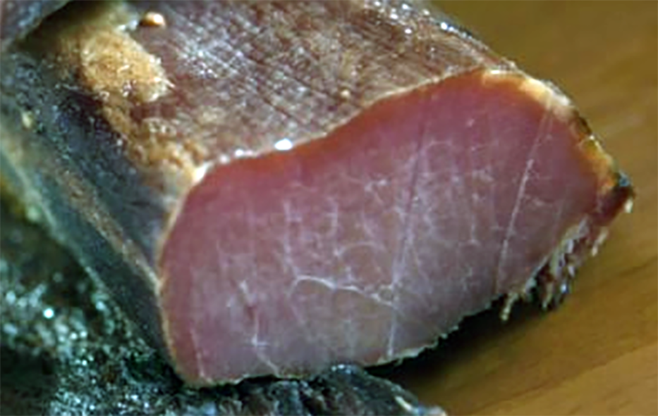 piece of cured veal on a wooden work surface