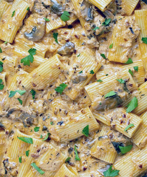 Tubular pasta in a mayonnaise, tuna and goat cheese sauce garnished with flat-leaf parsley