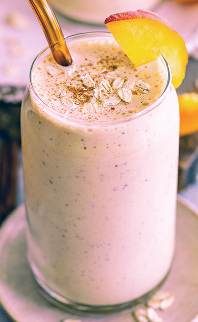Peaches and Dreams Smoothie garnished with a peach wedge