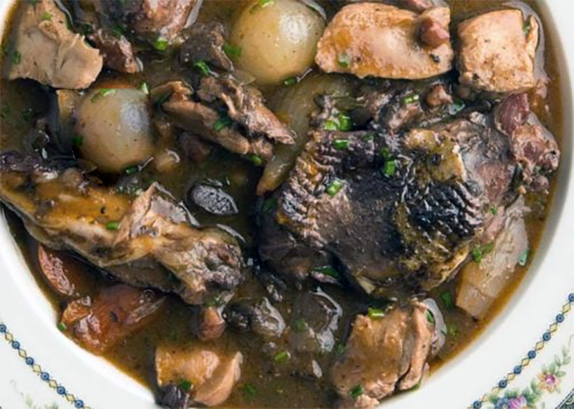 pheasant stew with shallots and mushrooms in a serving dish