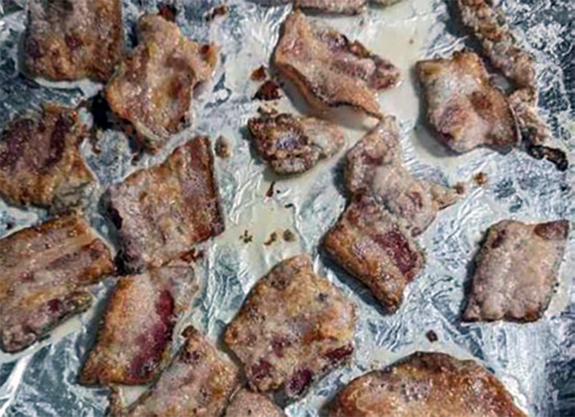 baked breaded bacon pieces on a sheet of foil