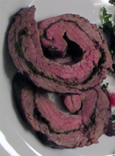 two slices of collard beef arranged on a plate