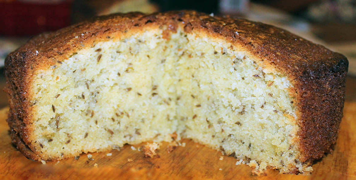 caraway sponge cake on a wooden chopping board