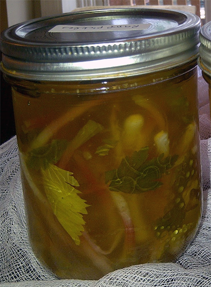 pickled wild leek bulbs in a jar with stems