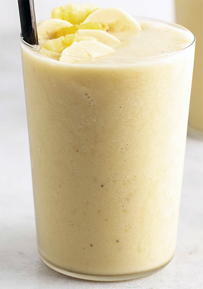 Pina banana smoothie in a glass topped with banana slices