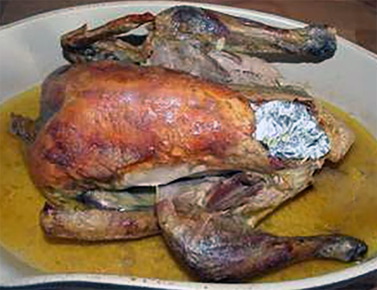 roast guinea fowl with stuffing with the stuffing covered in foil to prevent burning