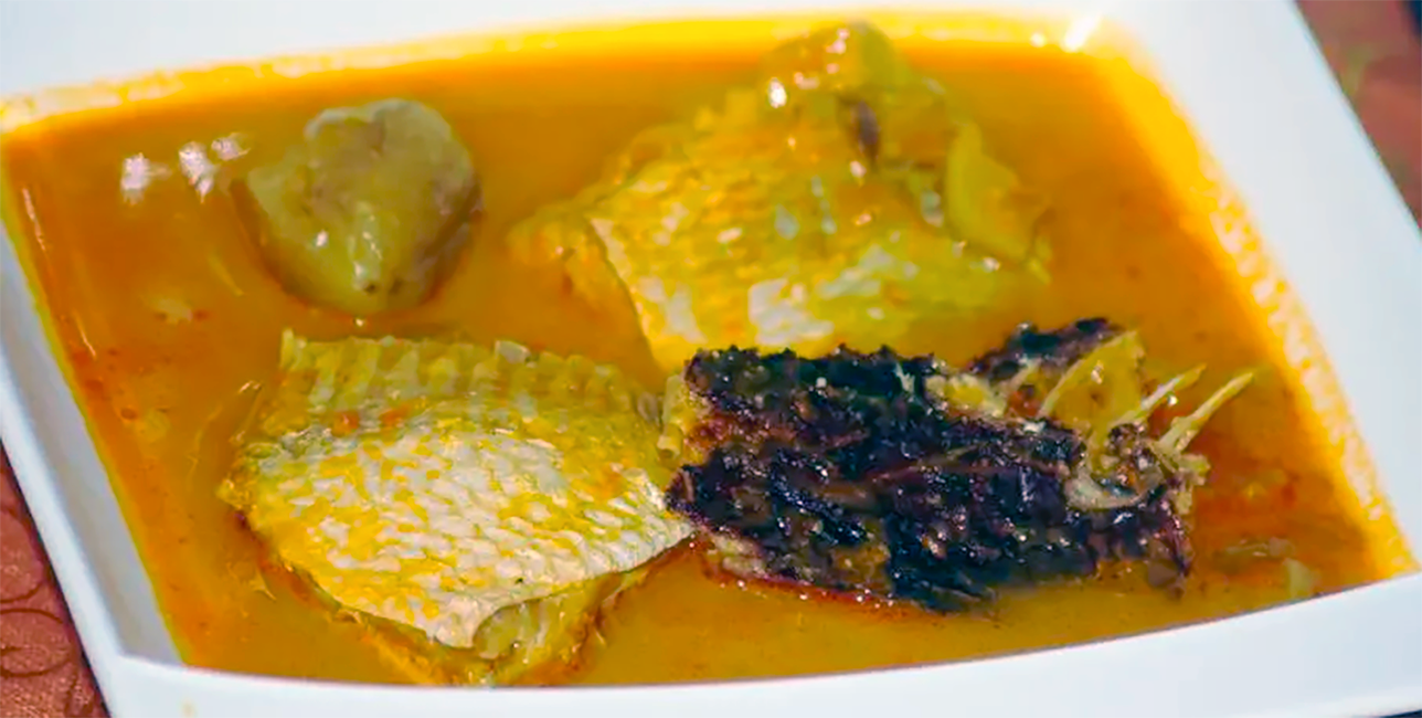 fish and garden eggs in a clear tomato and chilli sauce served in a white dish