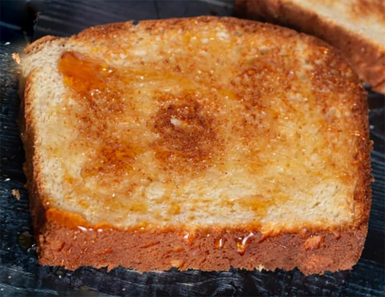 toasted and buttered slice of potato bread