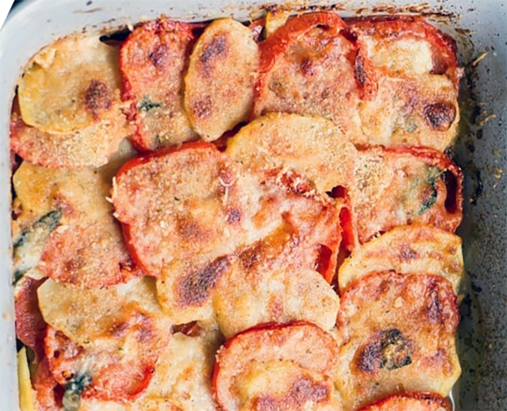 Potatoes baked in a tomato sauce in a baking dish